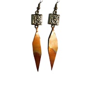 a pair of copper earrings with a square shape